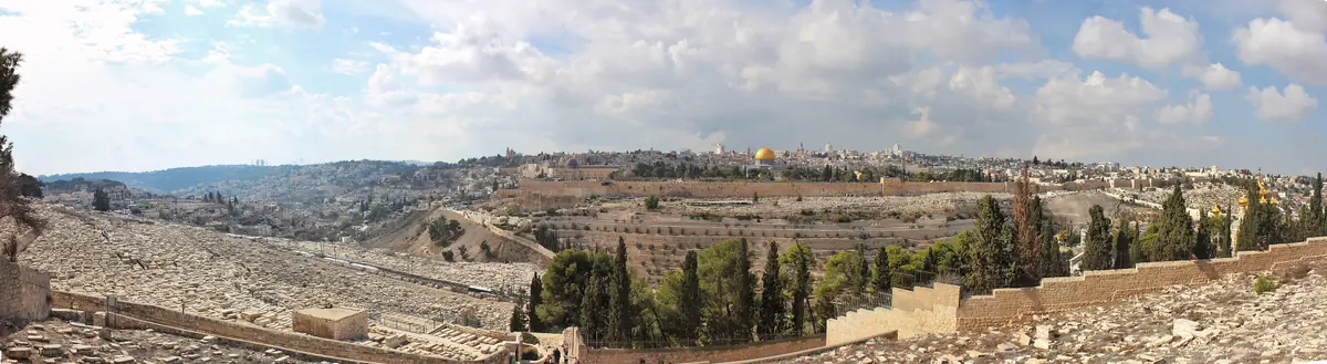 Panorama of Jerusalem from the Mount of Olives: white tombs in the foreground, the city walls and the golden Dome of the Rock in the centre
