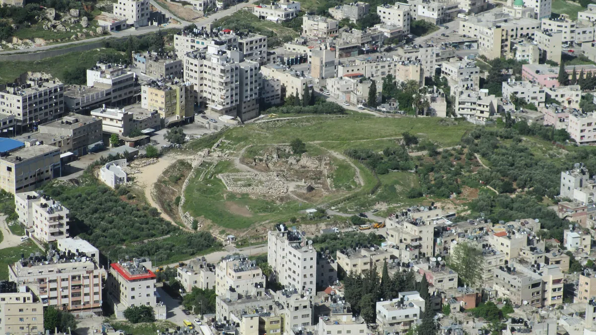 Tel Balata seen from above, a green space among the buildings of Nablus