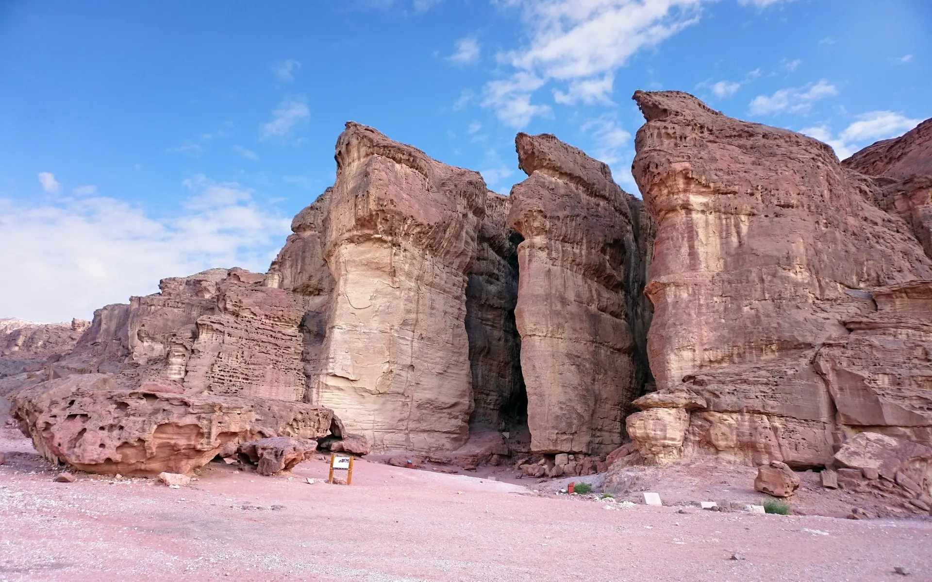 Solomon's Pillars, tall sandstone columns carved by erosion, under a blue sky at Timna